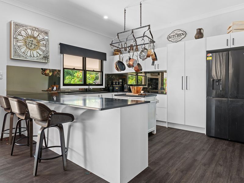 Modern kitchen with breakfast bar and premium finishes.