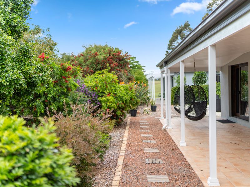 Lush landscaped garden pathway leading to the outdoor living area