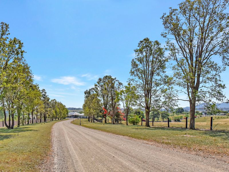 Long country driveway leading to the home and open fields