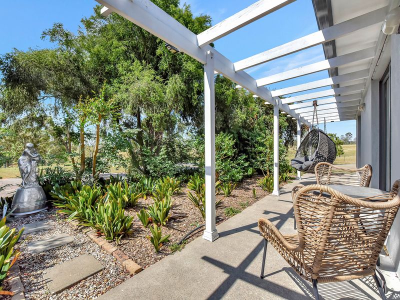 Garden pathway with greenery and shaded seating