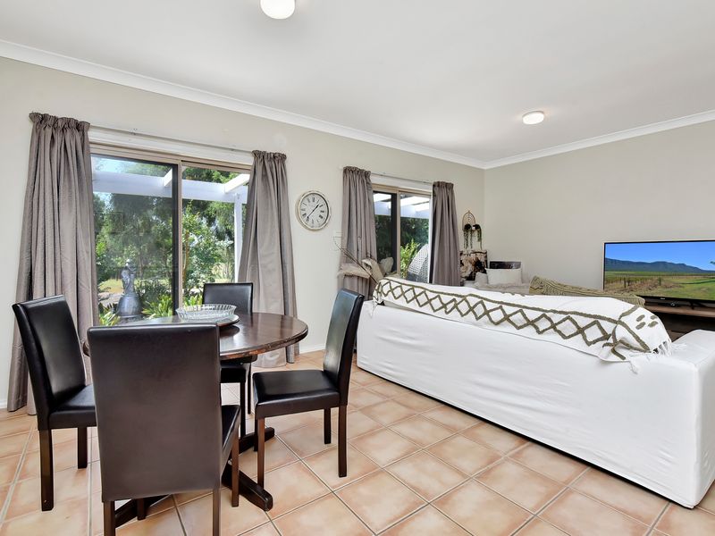 Light-filled living room with modern furnishings and TV