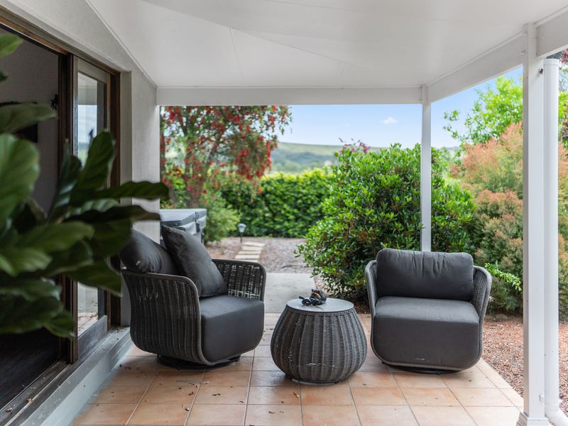 Covered outdoor lounge overlooking tranquil garden views