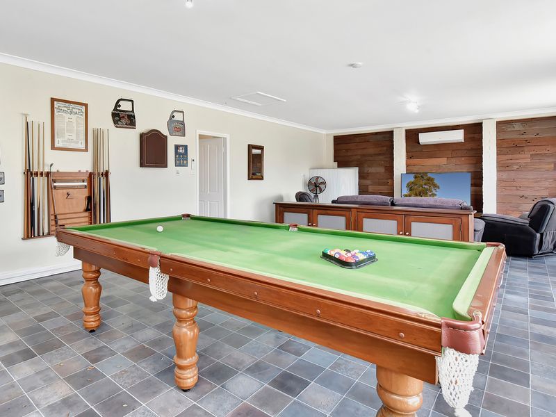 Spacious games room featuring a full-size pool table