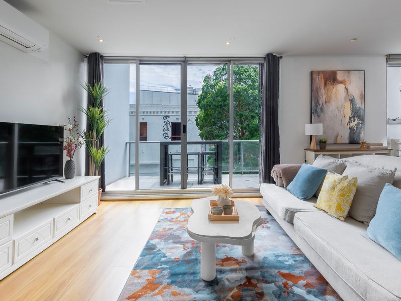 Comfortable lounge with smart TV and balcony access