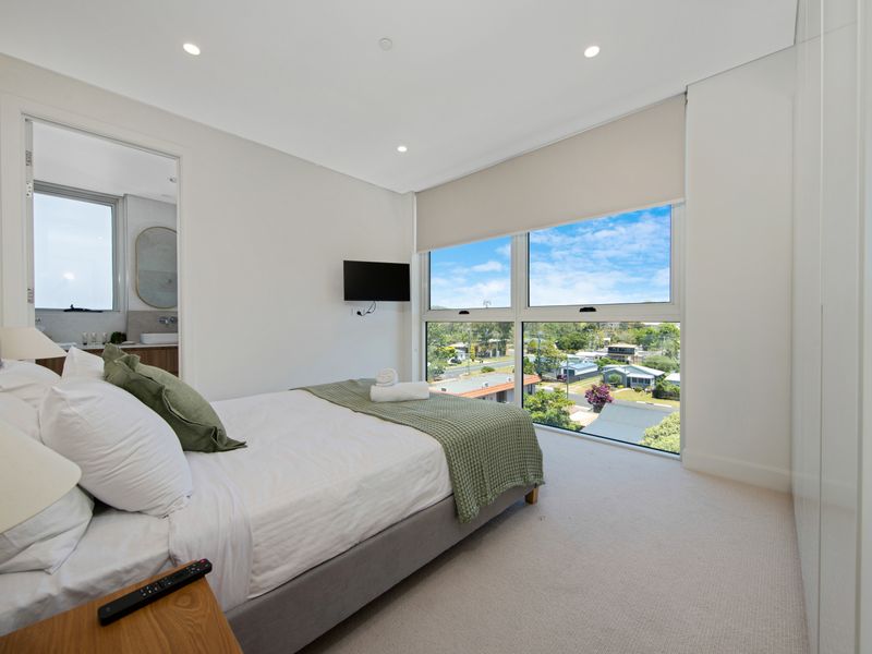 Bright bedroom with city views and smart TV