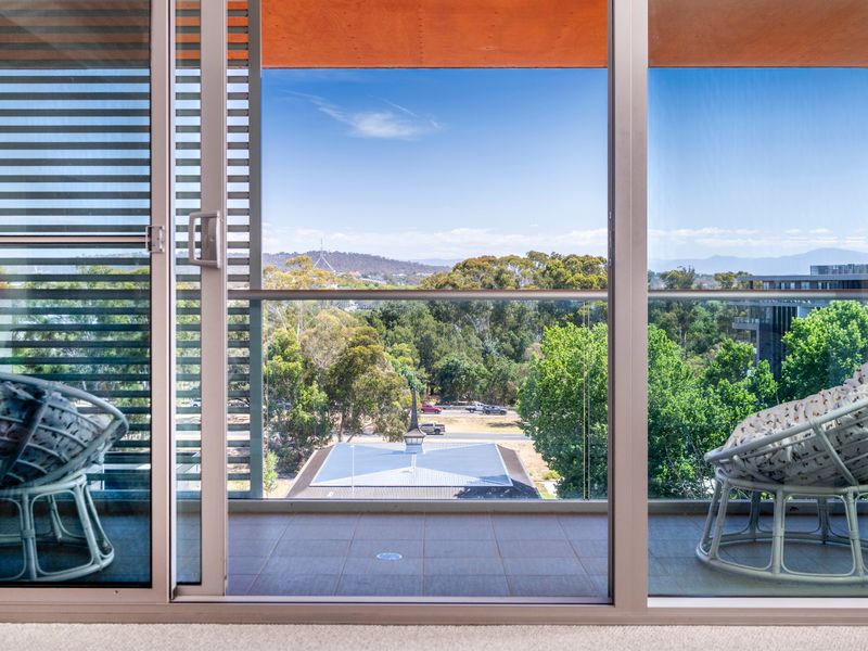Private balcony with outdoor seating and calming green views