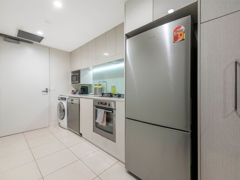 Internal laundry with washer, dryer, and full-size fridge