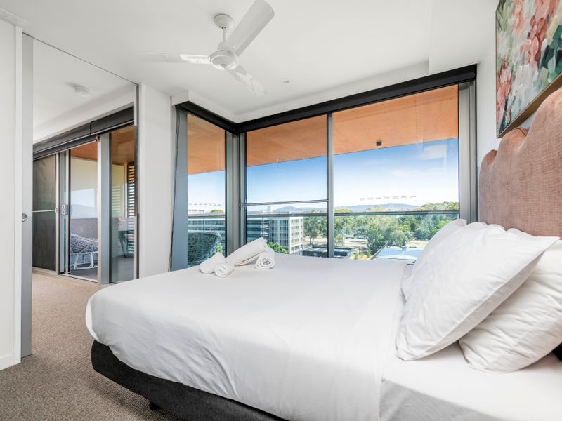 Serene bedroom with plush bedding and balcony access