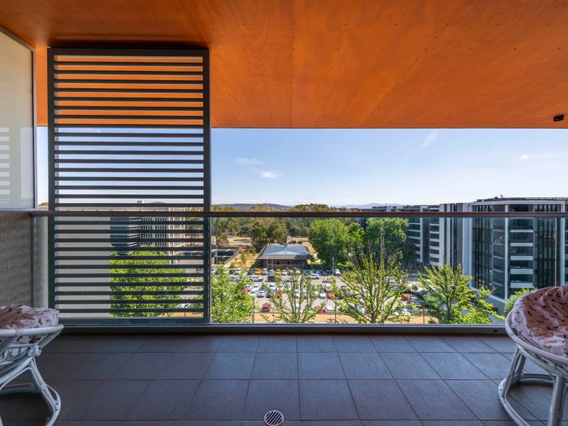 Covered balcony with outdoor seating and sweeping urban views