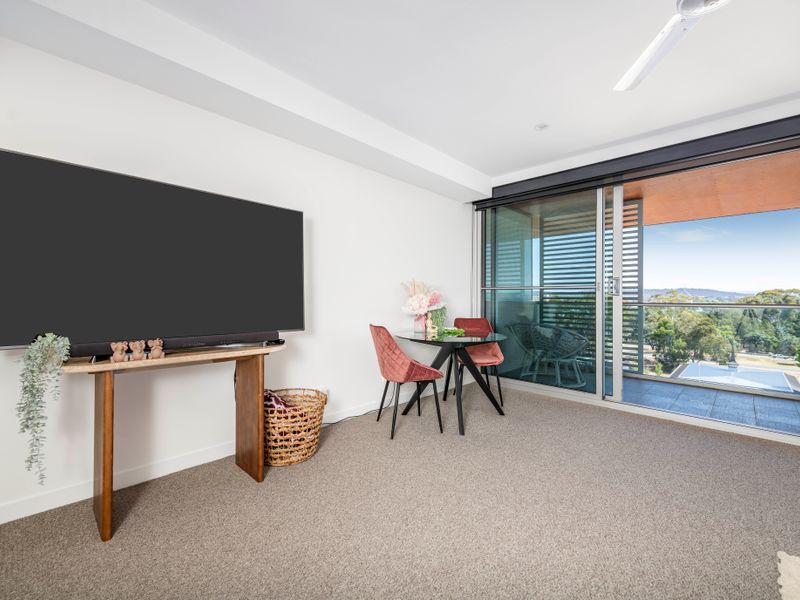 Cozy sitting nook with wall-mounted TV and balcony outlook