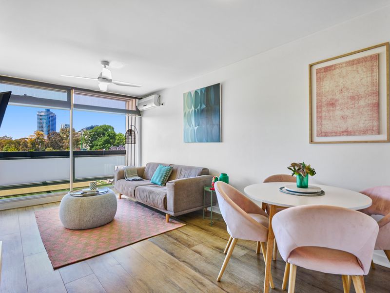 Bright open-plan living area with stunning park and city views