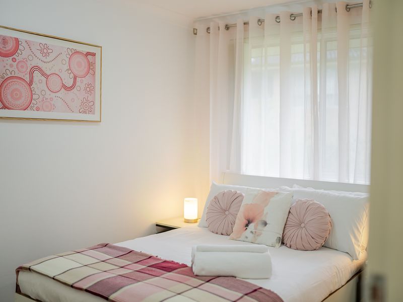 Calm sleeping space with warm, welcoming touches