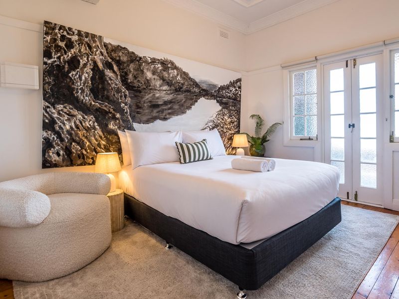 Stylish bedroom with comfortable queen bed and natural light