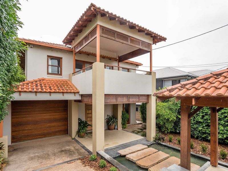 The exterior of the property showcases a striking two-story coastal contemporary design that emphasizes natural textures and elevated living.