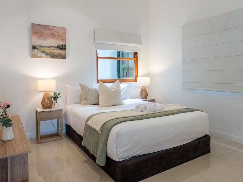 Showcases a 4th beautifully appointed sleeping space, continuing the home's theme of calm, coastal-inspired luxury.