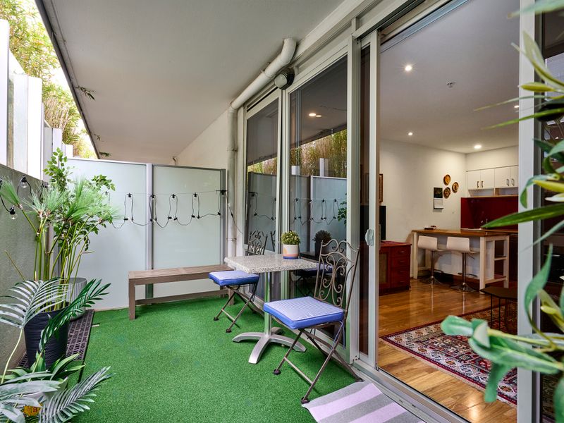 Private courtyard with seating, greenery, and a peaceful outlook