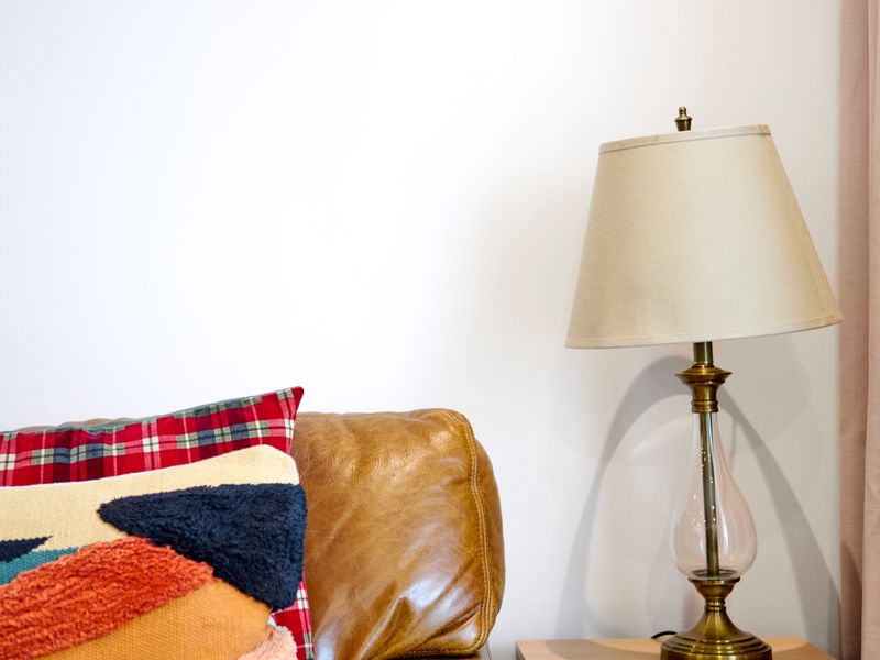 Relax on the plush leather sofa with soft pillows, perfect for unwinding after a day of exploring.