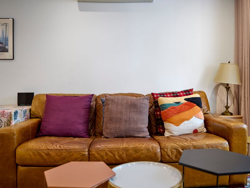 Cozy lounge seating with colourful cushions and artwork