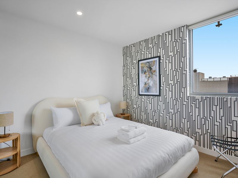 Bright bedroom with comfortable bedding and soft tones