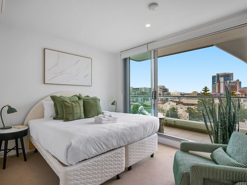 Serene bedroom with plush bedding and city outlook