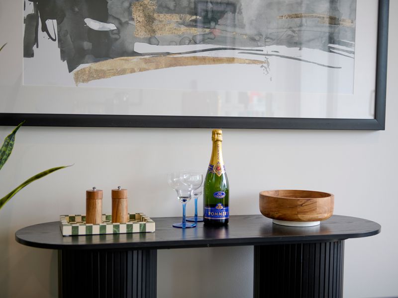 Stylish console with welcome drinks and glassware