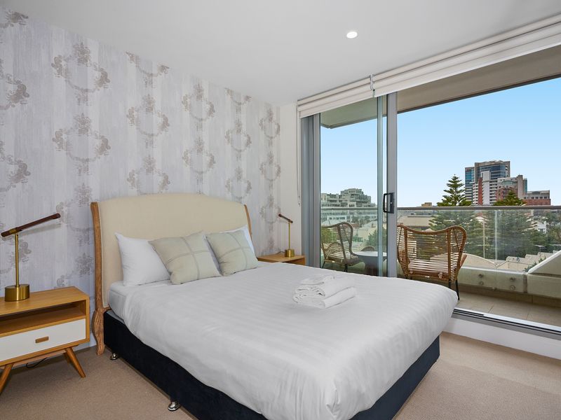 Peaceful bedroom with balcony access and natural light