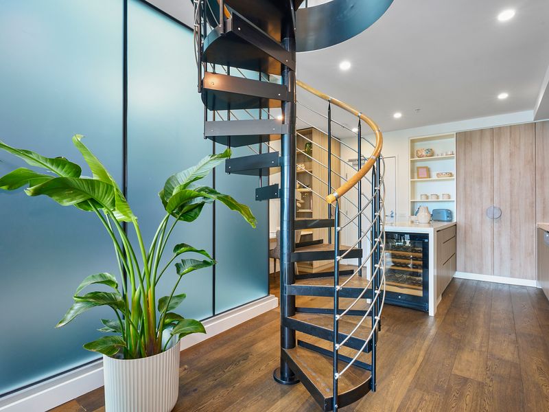 Unique spiral staircase leading to the upper level