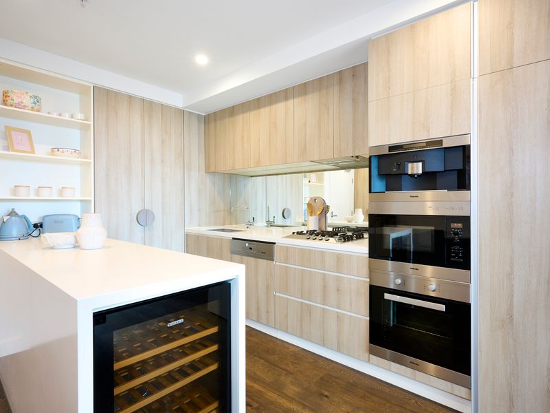 Contemporary kitchen with island bench and wine fridge