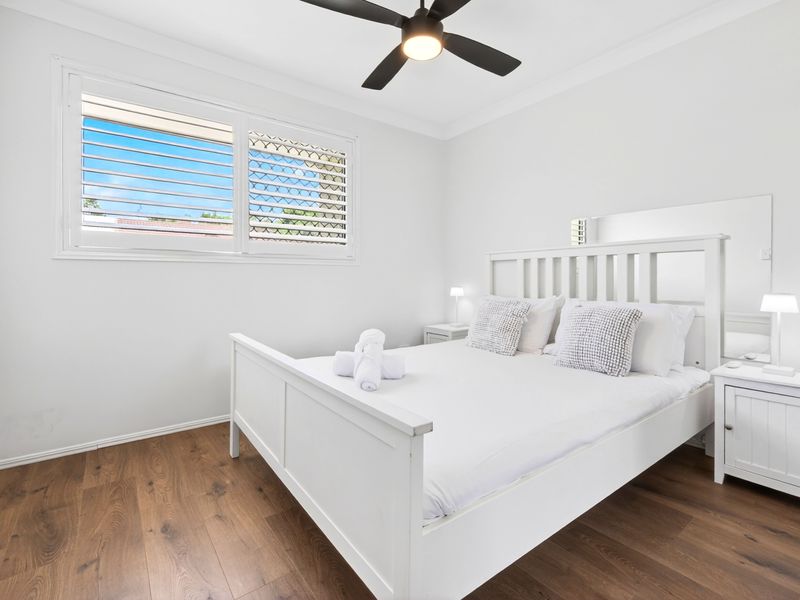 Light-filled guest bedroom with fresh linens