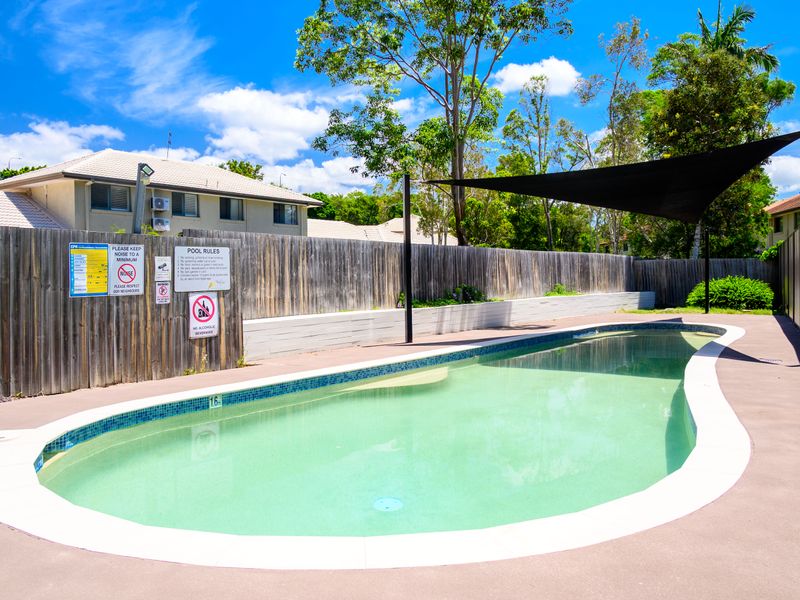 Peaceful poolside setting with shaded areas