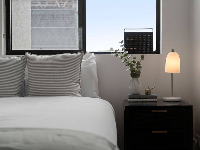 Thoughtfully styled bedside details for a hotel-like stay.