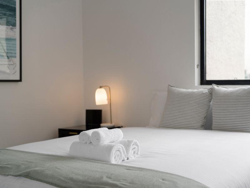 Restful bedroom retreat with soft lighting and fresh linens.