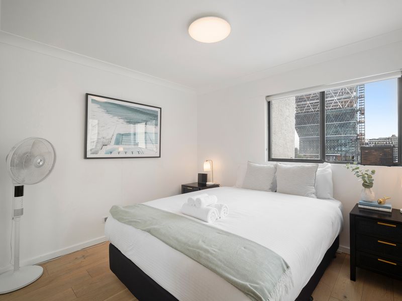 Bright and serene bedroom with plush bedding and natural light.