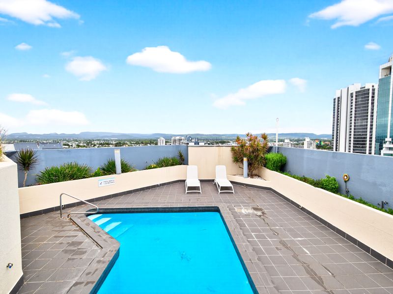 Sun-soaked pool with skyline backdrop