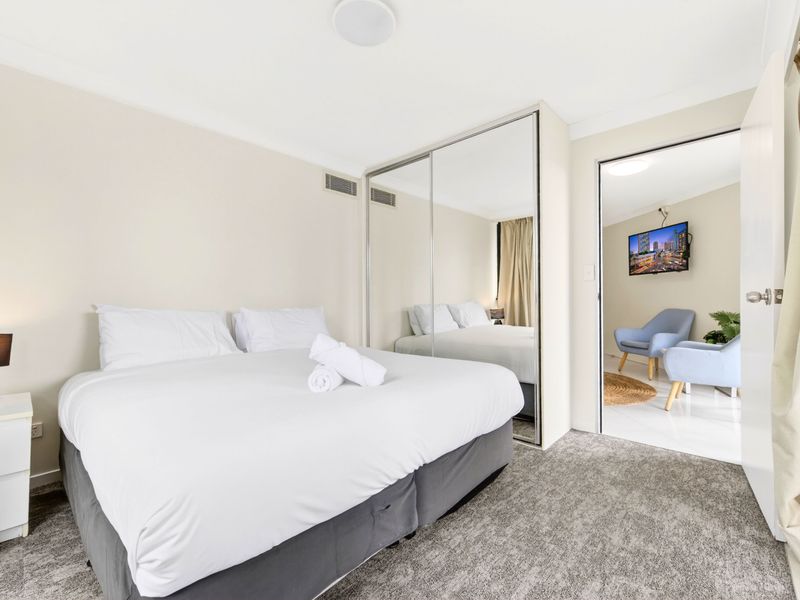 Spacious bedroom with mirrored wardrobes