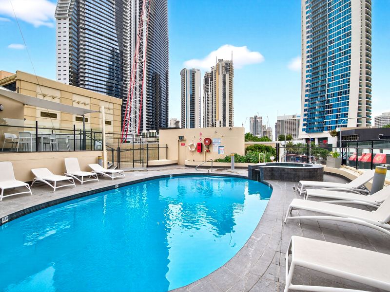 Spacious pool area surrounded by city towers