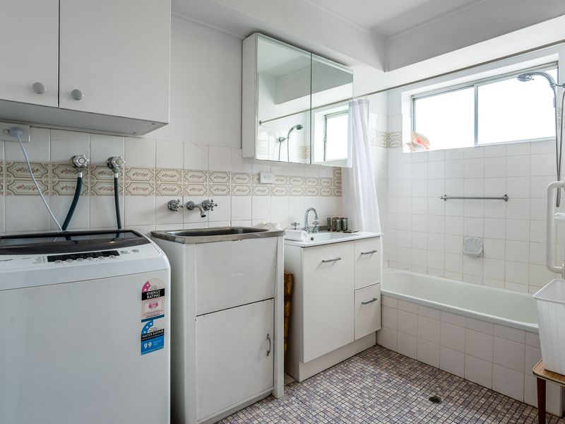 Laundry area with washing machine for guest use