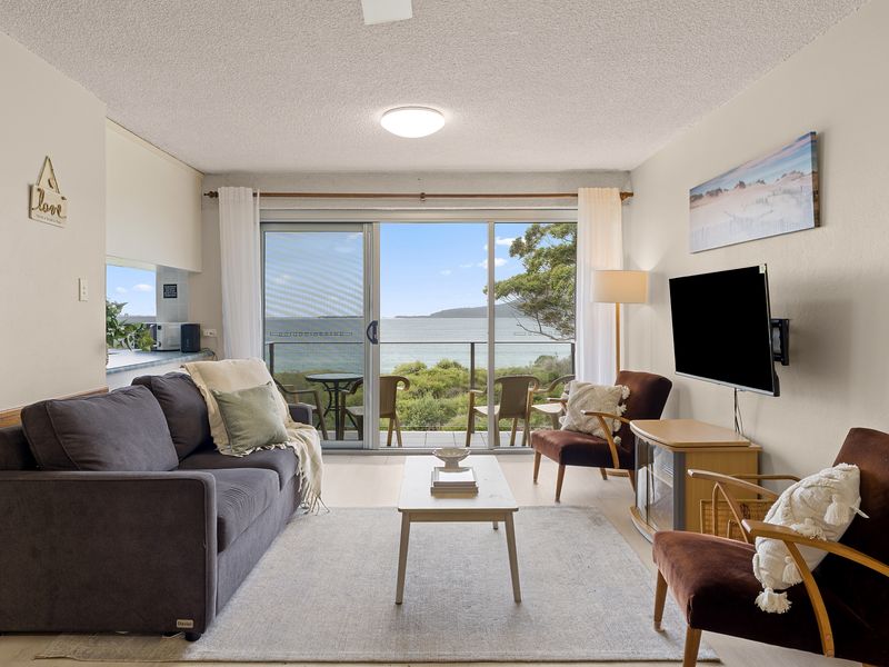Bright living area with comfy seating and stunning water views
