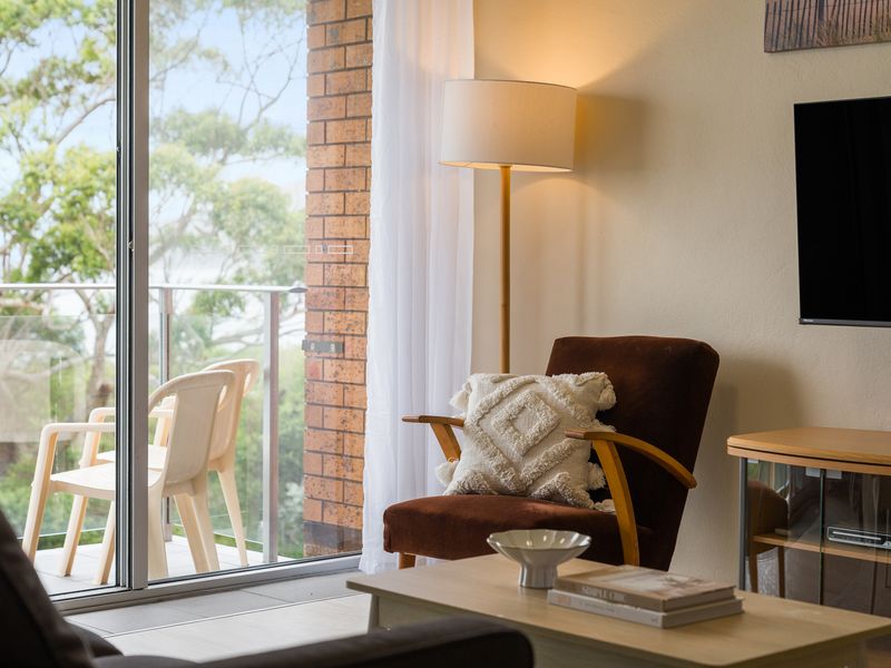 Cozy reading corner with natural light and balcony access