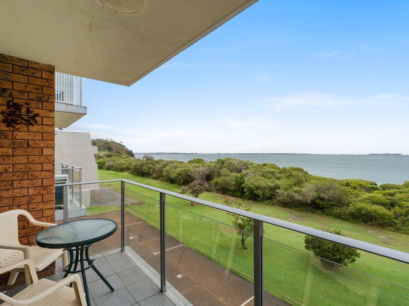 Private balcony with outdoor seating and ocean breeze