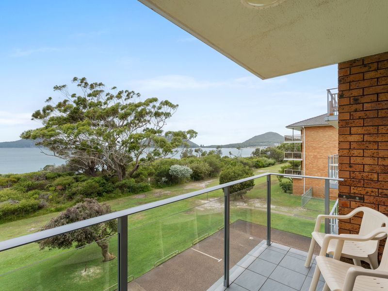 Private balcony with seating and sweeping coastal views