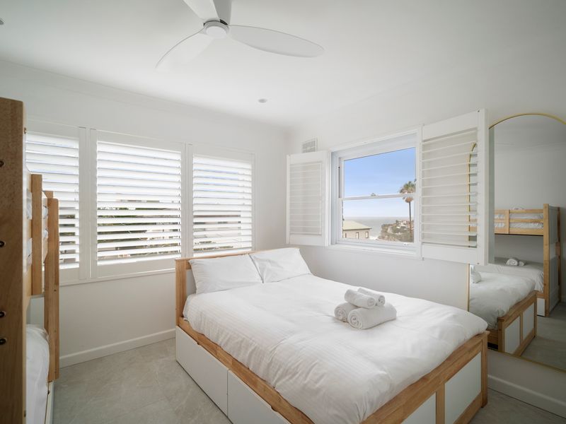 Sunny bedroom with plantation shutters and ocean breeze