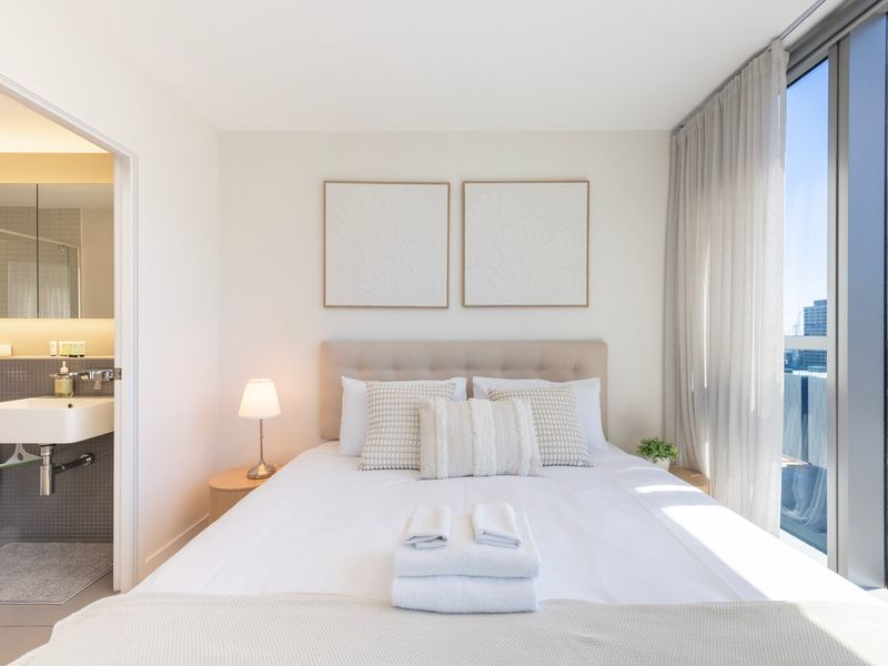 Master bedroom with hotel-quality linen and natural light