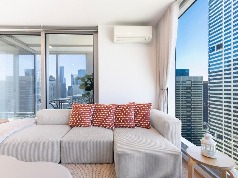 Comfortable sofa seating with natural light and city views