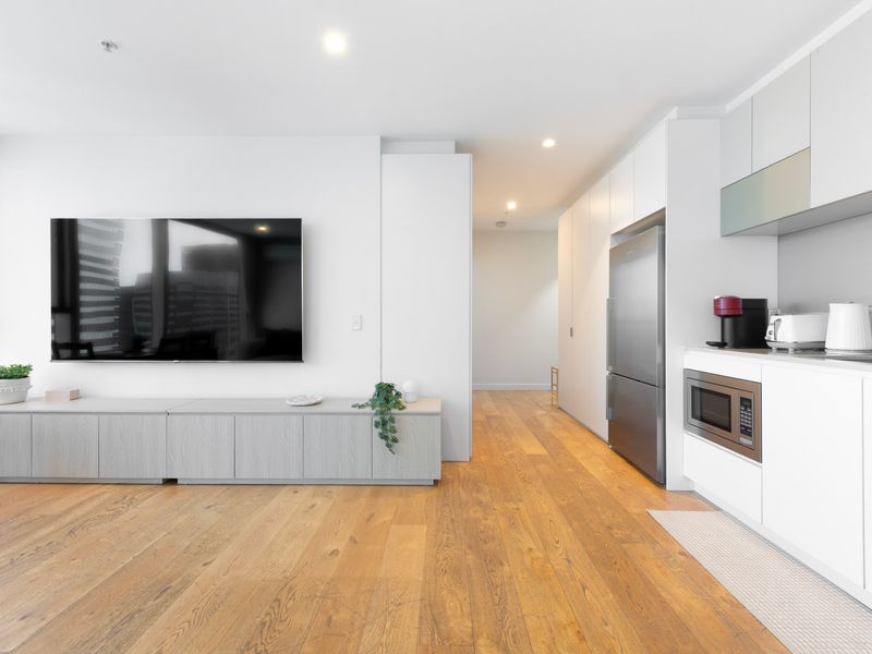 Open living area with large TV and sleek finishes