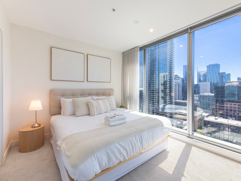 Master bedroom with floor-to-ceiling windows and skyline outlook