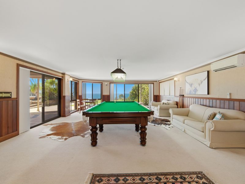 Spacious games room with pool table and comfy seating