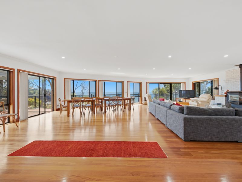 Spacious living and dining area with polished timber floors
