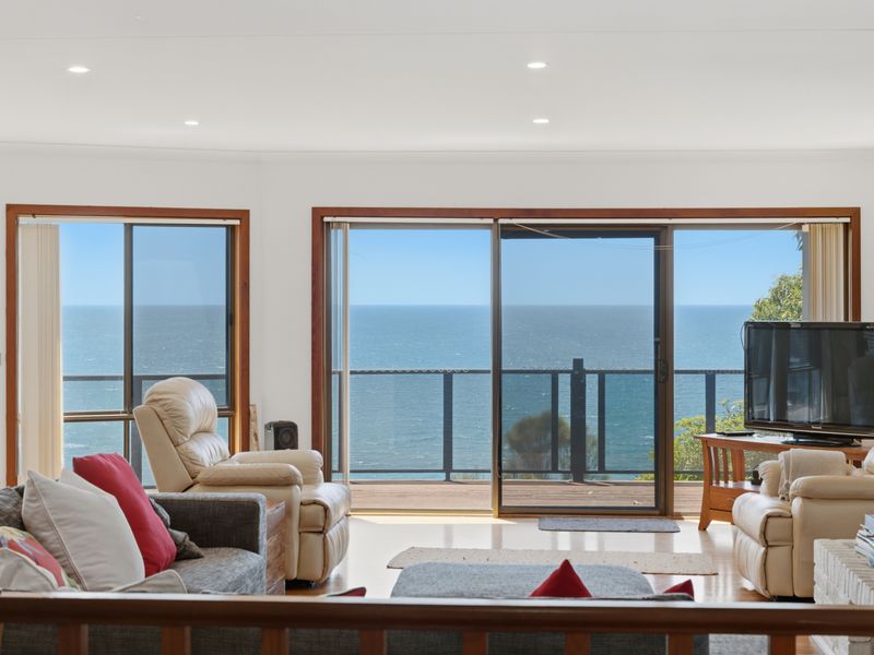 Bright sitting area framed by endless blue horizons