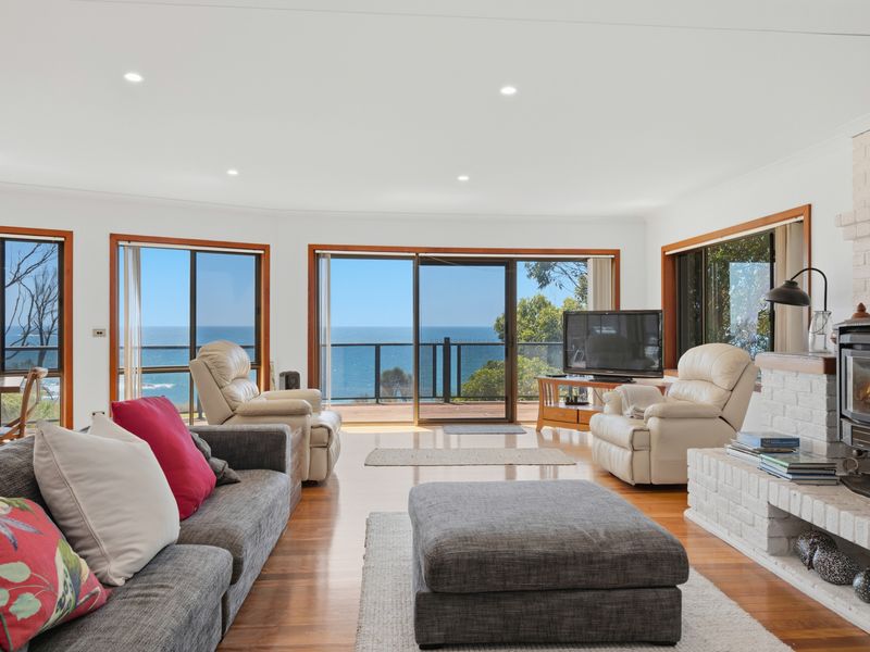 Relax in comfort with expansive windows overlooking the sea
